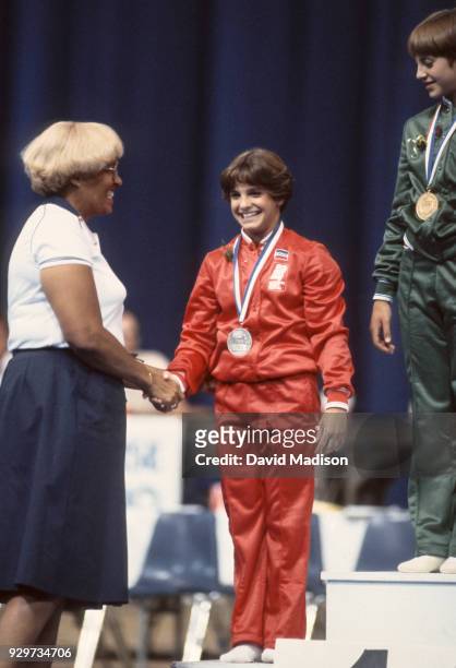 Dr. Evie Dennis congratulates Mary Lou Retton during an awards ceremony at the gymnastics competition of the 1981 National Sports Festival held in...
