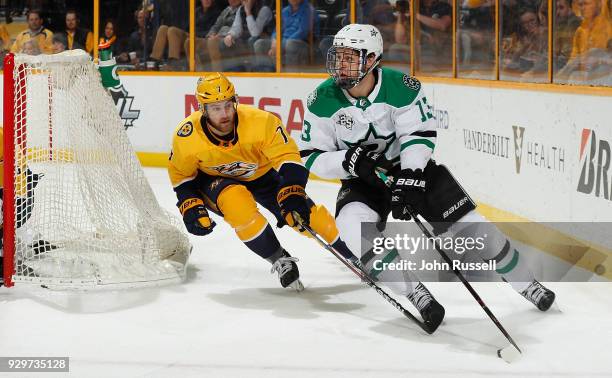 Mattias Janmark of the Dallas Stars skates against Yannick Weber of the Nashville Predators during an NHL game at Bridgestone Arena on March 6, 2018...