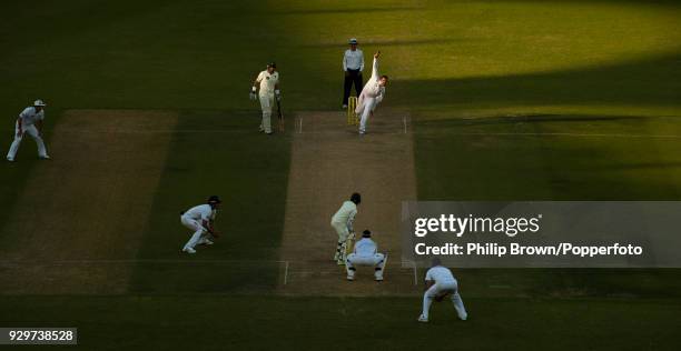 Graeme Swann of England bowls to Pakistan batsman Adnan Akmal as the shadows cross the pitch during the 1st Test match between Pakistan and England...