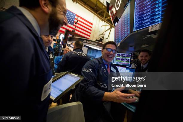 Traders work on the floor of the New York Stock Exchange in New York, U.S., on Friday, March 9, 2018. U.S. Stocks rose while Treasuries fell as the...