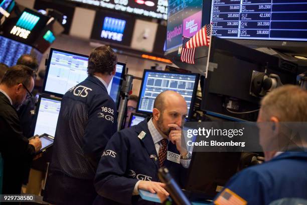 Traders work on the floor of the New York Stock Exchange in New York, U.S., on Friday, March 9, 2018. U.S. Stocks rose while Treasuries fell as the...