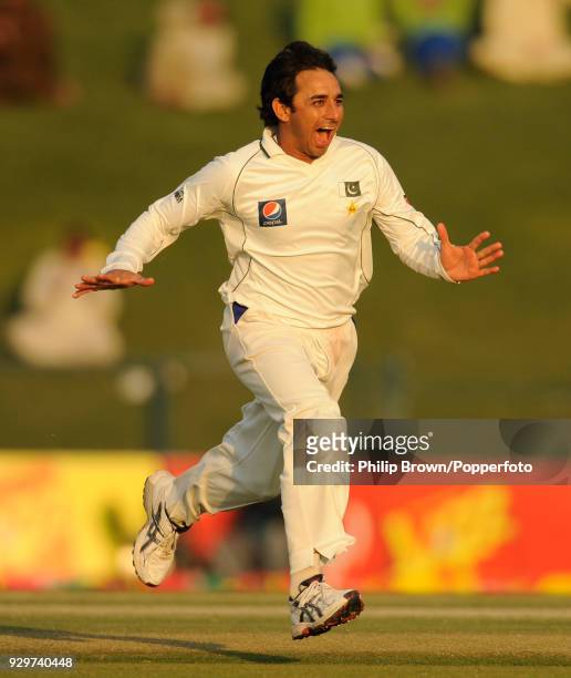 Saeed Ajmal of Pakistan celebrates after dismissing England batsman Eoin Morgan during the 2nd Test match between Pakistan and England at the Sheikh...