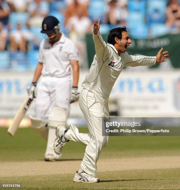 Pakistan's Saeed Ajmal celebrates after dismissing England's Jonathan Trott for 18 runs in the 3rd Test match between Pakistan and England at Dubai...