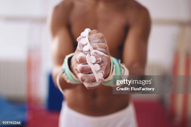 gymnast applying sports chalk - artistic gymnastics stock pictures, royalty-free photos & images