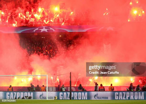 Hundreds of smokes illuminate the 'Tribune Auteuil' during the UEFA Champions League Round of 16 Second Leg match between Paris Saint-Germain and...