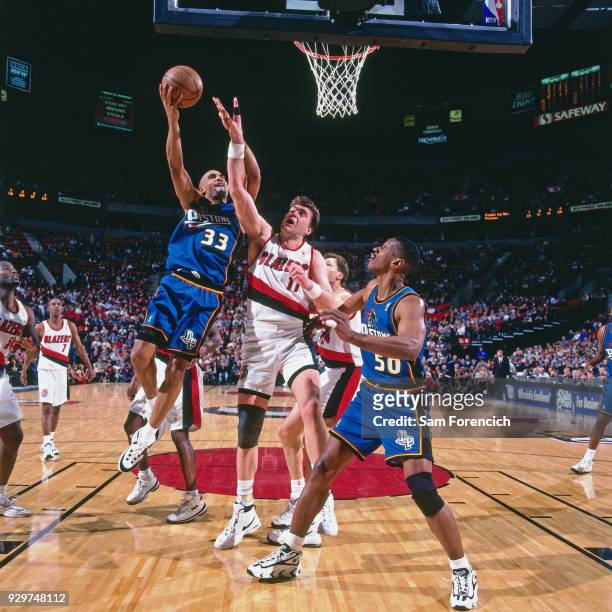 Grant Hill of the Detroit Pistons shoots circa 1997 at the Rose Garden in Portland, Oregon. NOTE TO USER: User expressly acknowledges and agrees...
