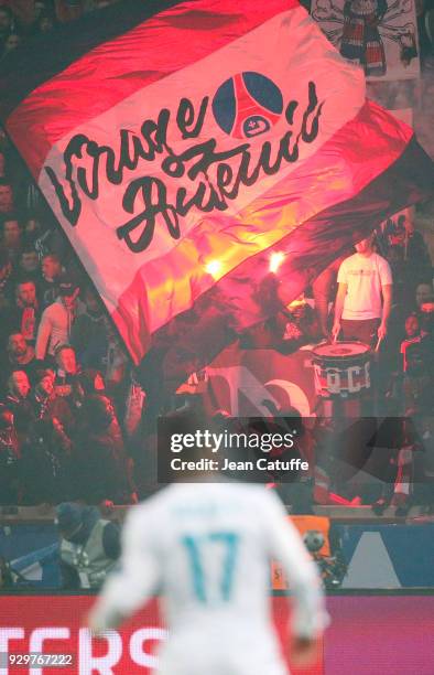 Hundreds of smokes illuminate the 'Tribune Auteuil' during the UEFA Champions League Round of 16 Second Leg match between Paris Saint-Germain and...