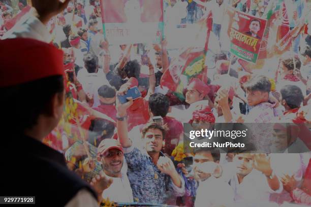 Samajwadi Party's national president and former Chief Minister of state of Uttar Pradesh Akhilesh Yadav waves towards party supporters during his...