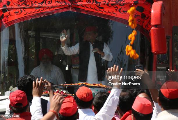 Samajwadi Party's national president and former Chief Minister of state of Uttar Pradesh Akhilesh Yadav waves towards party supporters during his...