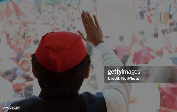 Samajwadi Party's national president and former Chief Minister of state of Uttar Pradesh Akhilesh Yadav waves towards party supporters during his...