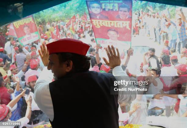 Samajwadi Party's national president and former Chief Minister of state of Uttar Pradesh Akhilesh Yadav waves towards party supporters during his...