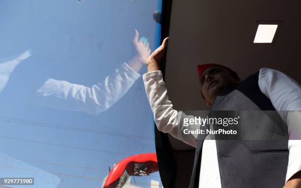 Samajwadi Party's national president and former Chief Minister of state of Uttar Pradesh Akhilesh Yadav waves towards party supporters during his...
