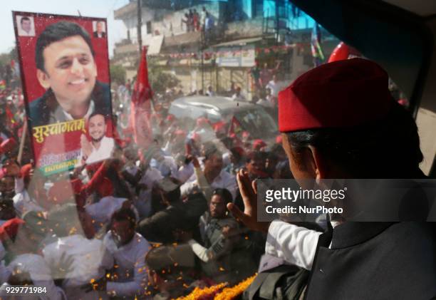 Samajwadi Party's national president and former Chief Minister of state of Uttar Pradesh Akhilesh Yadav waves towards party supporters during his...