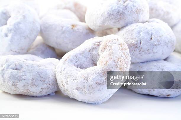white powdered sugar donuts on white background - icing sugar stock pictures, royalty-free photos & images