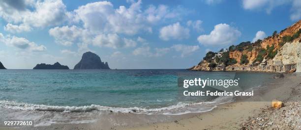 large panoramic of cala d'hort and es vedrà island, ibiza island - beach at cala d'or stock pictures, royalty-free photos & images