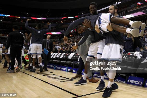 Will Leviton of the Rhode Island Rams is held up by teammates Michael Tertsea and Eric Dadika after a point against the Virginia Commonwealth Rams...