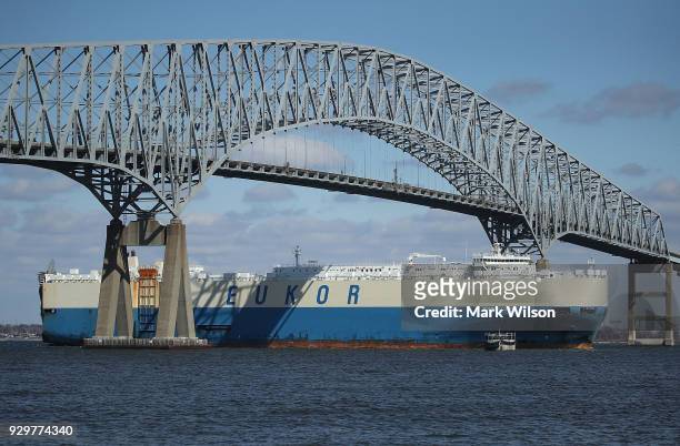 An outbound cargo ship passes under the Francis Scott Key Bridge, March 9, 2018 in Baltimore, Maryland. U.S. President Donald Trump announced that he...