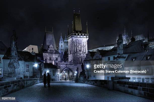 a couple chat on a romantic evening in prague - prague people stock pictures, royalty-free photos & images