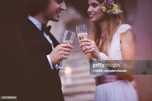 happy bride and groom drinking champagne on wedding day - boho wedding dresses stock pictures, royalty-free photos & images