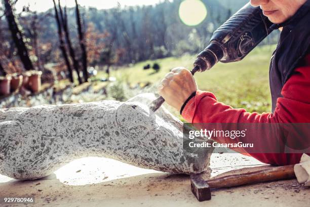 mature woman making sculpture from repen stone - facing things head on stock pictures, royalty-free photos & images