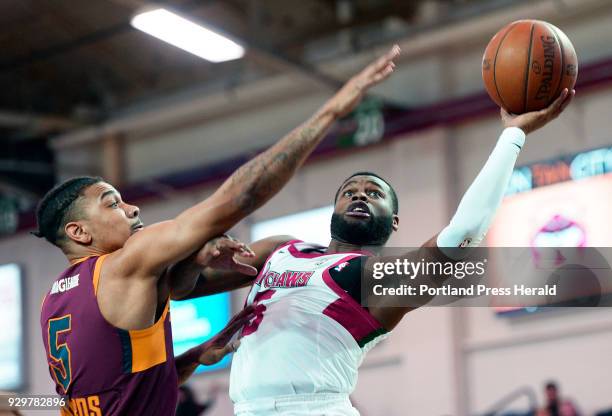 Kadeem Allen of the Red Claws drives past Arthur Edwards of Canton Thursday, March 8, 2018.