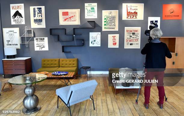 Camerawoman films posters of May 68 during an exhibition entitled "Mai 68 en 500 affiches" gathered by collector Laurent Storch for sale by the...