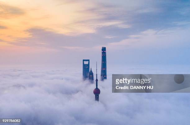 skyscrapers above advection fog in Lujiazui, Shanghai