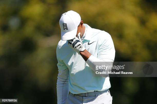 Tiger Woods reacts after playing his second shot on the seventh hole during the second round of the Valspar Championship at Innisbrook Resort...