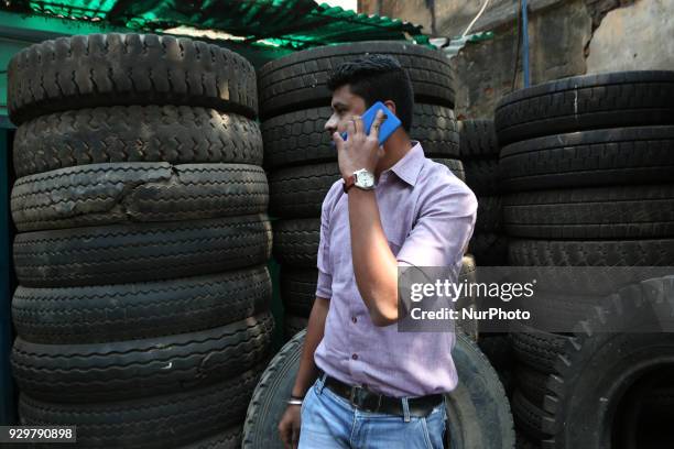 The Used Tyre repair a Narrow Side Street in Kolkata city before they are sold in a second-hand Motors Parts Market ,ALL SIZES Brand: GOODYEAR, CEAT,...