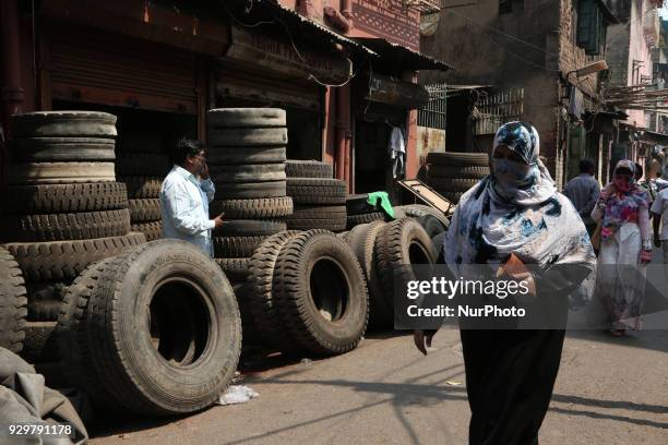 The Used Tyre repair a Narrow Side Street in Kolkata city before they are sold in a second-hand Motors Parts Market ,ALL SIZES Brand: GOODYEAR, CEAT,...