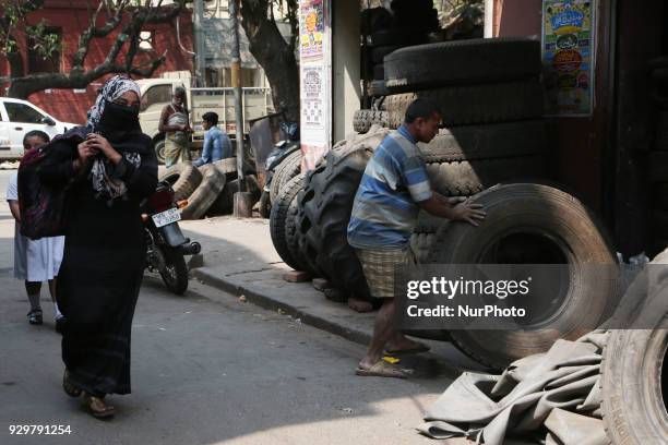 The Used Tyre repair a Narrow Side Street in Kolkata city before they are sold in a second-hand Motors Parts Market ,ALL SIZES Brand: GOODYEAR, CEAT,...