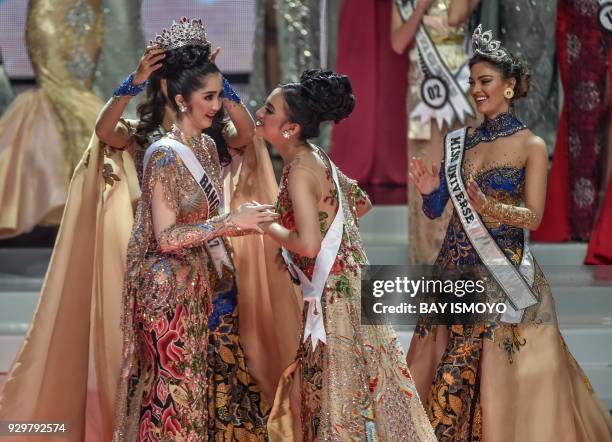 Miss Indonesia 2018 Sonia Fergina is crowned as South Africa's Miss Universe Demi-Leigh Nel-Peters and runner up contestant Vania Fitryanti look on...