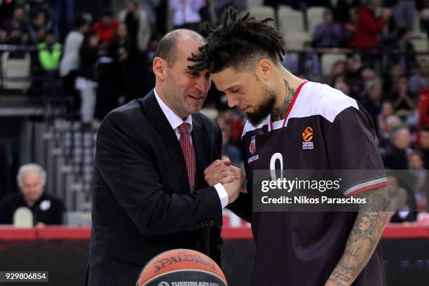 President of Olympiacos Piraeus George Aggelopoulos gives an award to Daniel Hackett, #0 of Brose Bamberg, for his offer to the team before the...