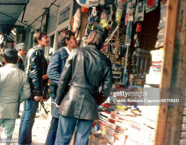 Three armed Russians shopping for souvenirs in Kabul during the invasion of Afghanistan by the Russians, January 1980.