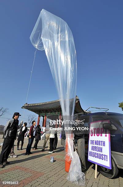 South Korean human rights activists prepare to launch anti-North Korean leaflets in a large balloon at Imjingak peace park in Paju, near the...
