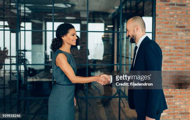 business people shaking hands - business relationship stock pictures, royalty-free photos & images