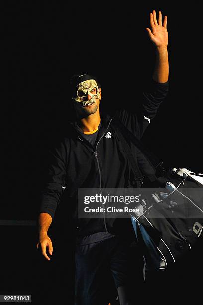 Novak Djokovic of Serbia enters the court wearing a mask during his match against Juan Monaco of Spain during the ATP Masters Series at the Palais...