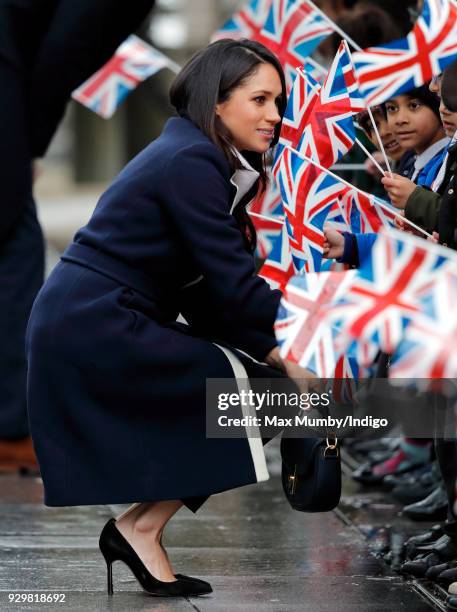 Meghan Markle meets children during a walkabout at Millennium Point before attending an event to celebrate International Women's Day on March 8, 2018...