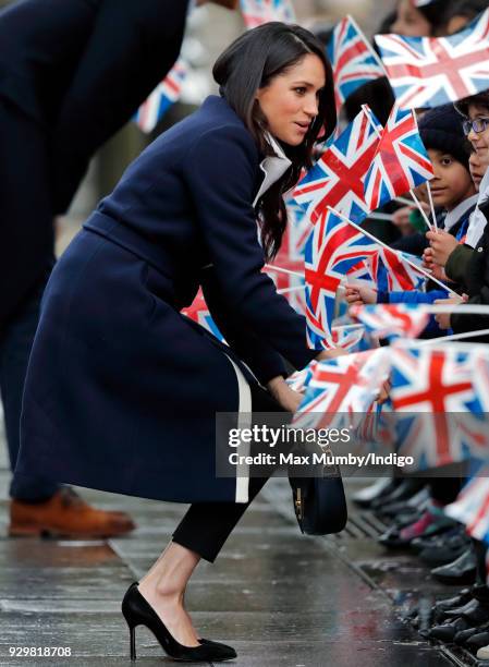 Meghan Markle meets children during a walkabout at Millennium Point before attending an event to celebrate International Women's Day on March 8, 2018...