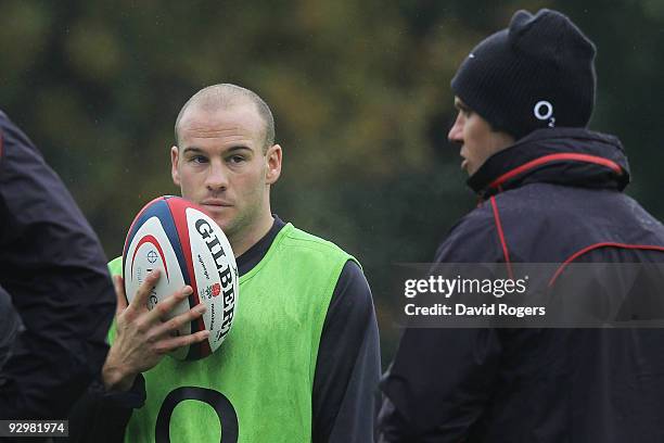 Scrumhalf Paul Hodgson listens to coach Brian Smith during the England training session at Pennyhill Park on November 11, 2009 in Bagshot, England.