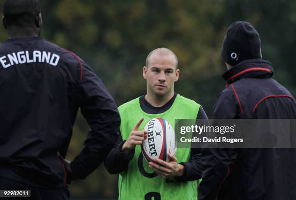 Scrumhalf Paul Hodgson listens to coach Brian Smith during the England training session at Pennyhill Park on November 11, 2009 in Bagshot, England.