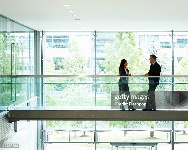 portrait of two business people talking - relación de negocios fotografías e imágenes de stock