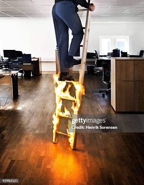 businessman climbing ladder on fire - escaping office stock pictures, royalty-free photos & images