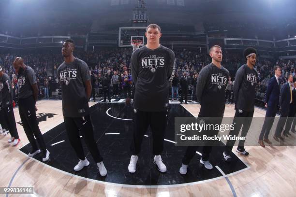 Timofey Mozgov of the Brooklyn Nets stands alongside teammates during the national anthem of the game against the Sacramento Kings on March 1, 2018...