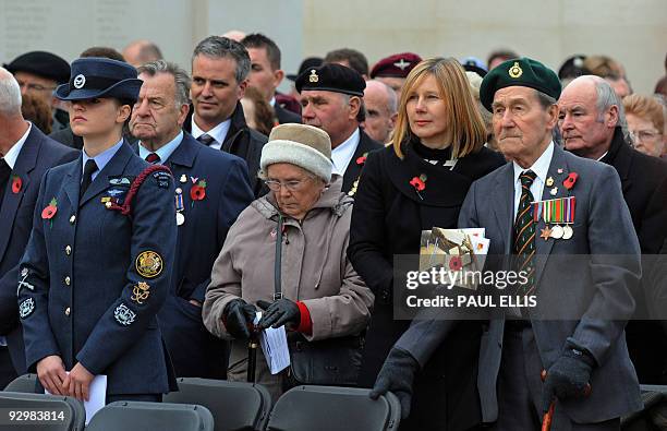 Veteran stands with serving military personnel as Britain's Prince Edward, Earl of Wessex lays a poppy wreath at The Armed Forces Memorial at the...