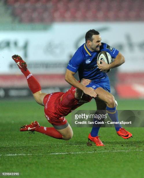 Leinster's Dave Kearney is tackled by Scarlets' Jonathan Evans during the Guinness Pro14 Round 17 match between Scarlets and Leinster Rugby at Parc y...