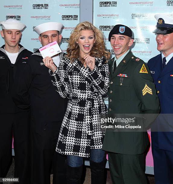 Actress AnnaLynne McCord poses with troops and collects Kisses for the Troops at Military Island, Times Square on November 11, 2009 in New York City.