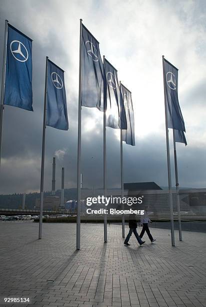 Flags bearing the Mercedes-Benz company logo hang outside the Mercedes Museum in Stuttgart, Germany, on Wednesday, Nov. 11, 2009. The chief executive...