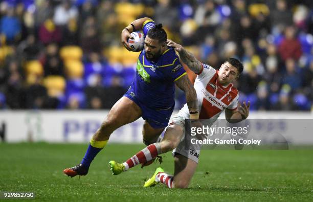 Ben Murdoch-Masila of Warrington is tackled by Mark Percival of St Helens during the Betfred Super League between Warrington Wolves and St Helens on...