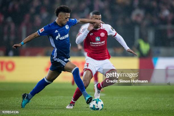 Thilo Kehrer of Schalke is challenged by Robin Quaison of Mainz during the Bundesliga match between 1. FSV Mainz 05 and FC Schalke 04 at Opel Arena...